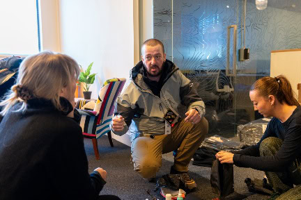 A group of people sitting in a room AI-generated content may be incorrect.