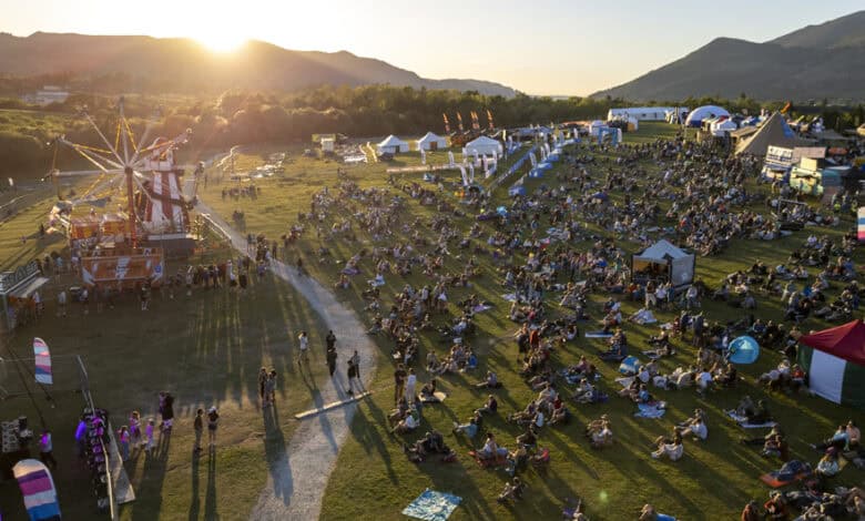 Crowd enjoying outdoor festival at Keswick Mountain Festival with mountains in background.