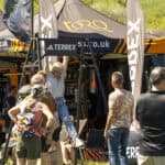 Outdoor event with people gathered around outdoor gear displays at Keswick Mountain Festival.