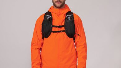 Bright orange waterproof trail jacket for outdoor hiking and trekking, with a breathable design.