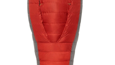 Red insulated sleeping bag with Sierra Designs logo, designed for outdoor camping adventures.
