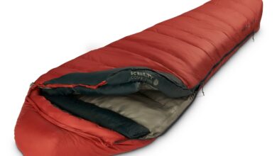 Warm red mummy sleeping bag for wild camping and outdoor adventures.