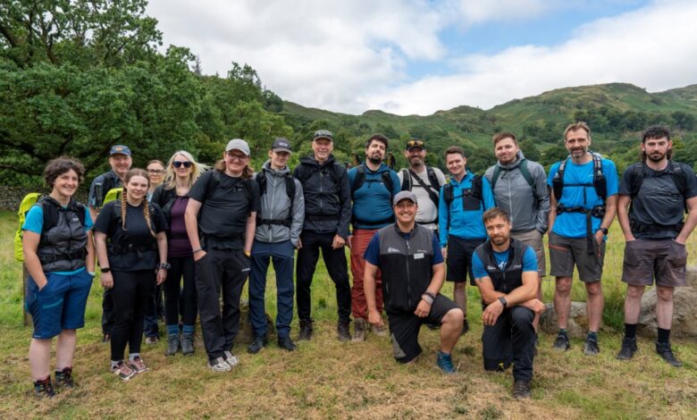 Hiking group outdoors in green landscape, hiking gear, backpacks, scenic mountain view, outdoor adventure, team activity, nature walk.