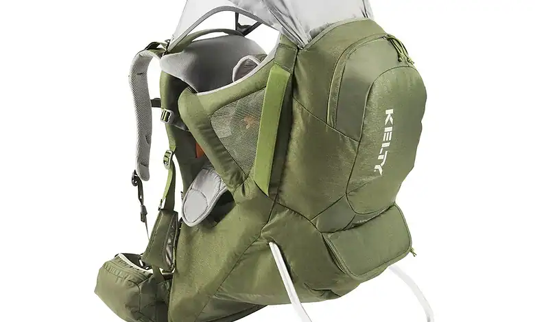 Moss green baby carrier with adjustable straps and sunshade for outdoor use.