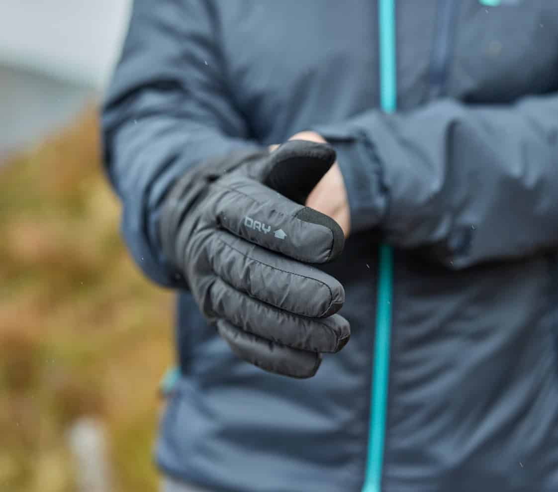 Close-up of waterproof outdoor gloves worn during outdoor activity.