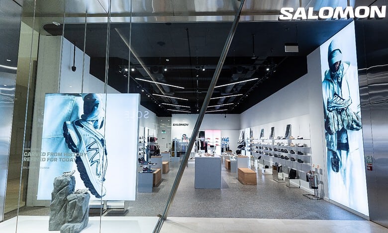 Salomon store interior showcasing outdoor footwear and apparel displays.