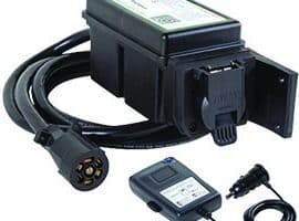 A Tekonsha Prodigy RF wireless trailer brake controller with its components laid out.