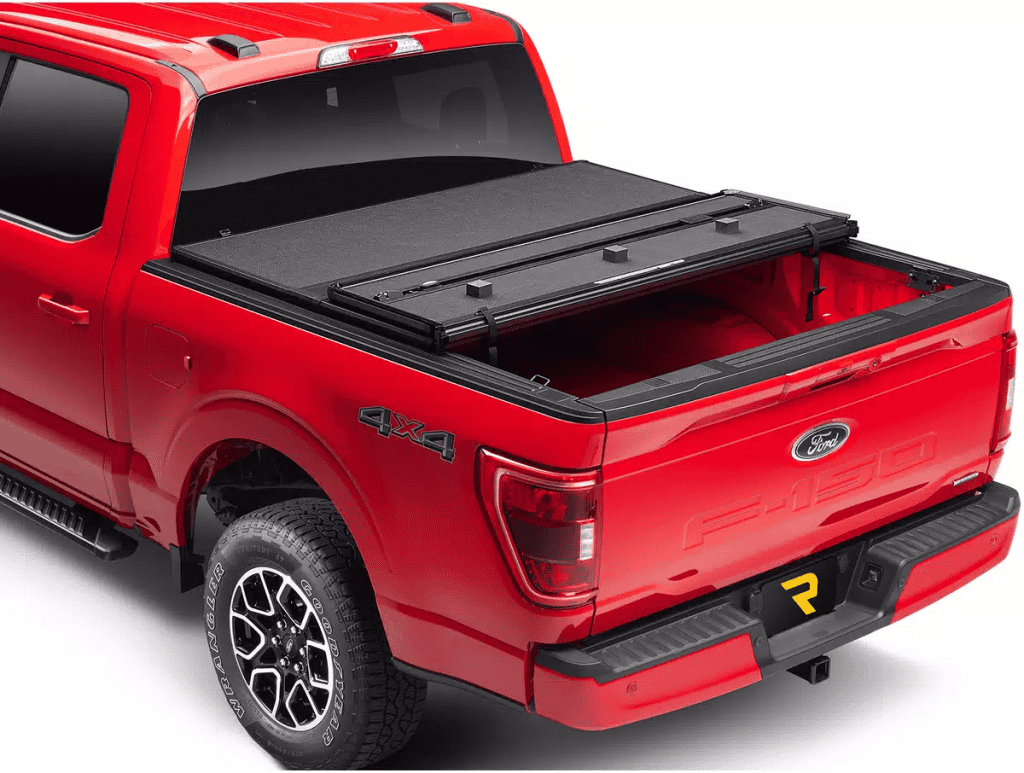 This image features a red Ford pickup truck equipped with a sturdy bed cover and bumper, showcasing durability and off-road readiness.