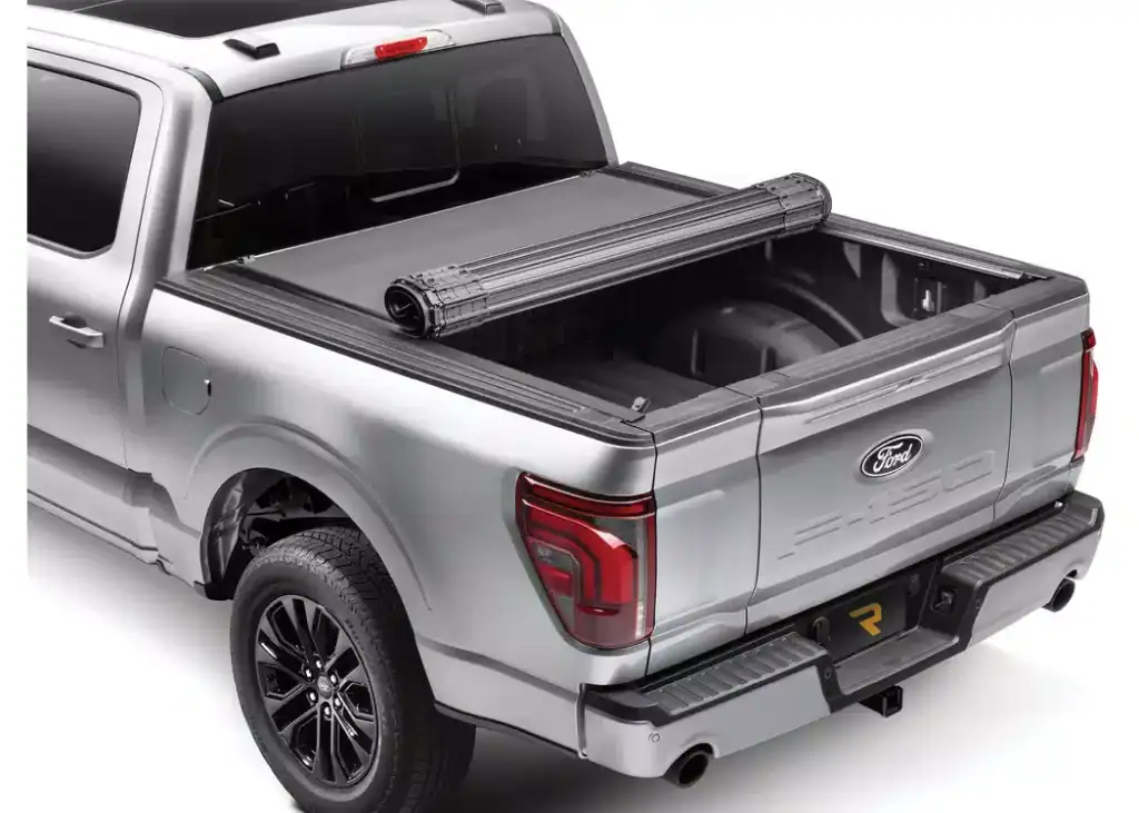Ford pickup truck with a protective bumper guard and bed cover for enhanced durability.