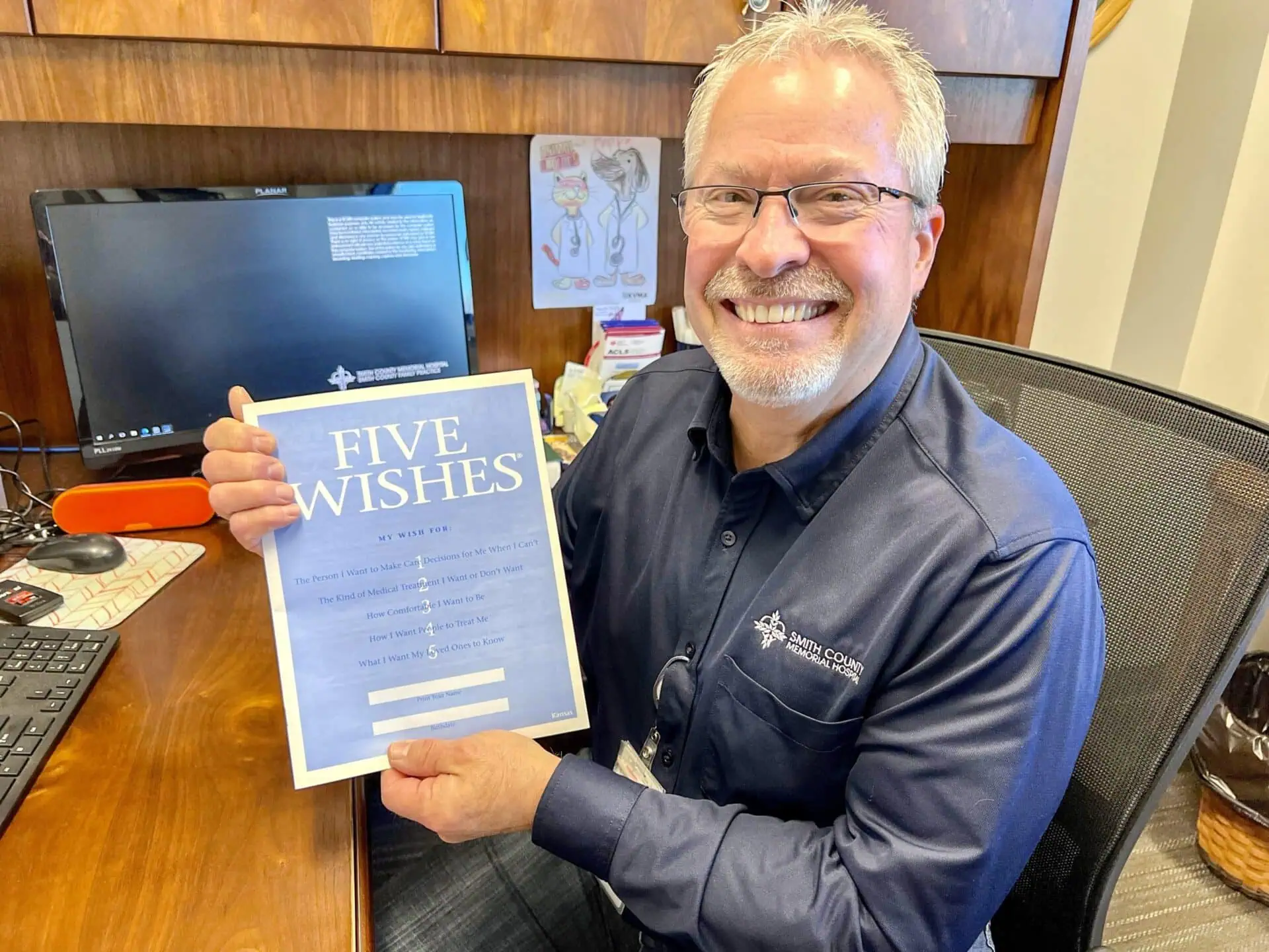Dr. Conant holds the Five Wishes advance care planning packet.