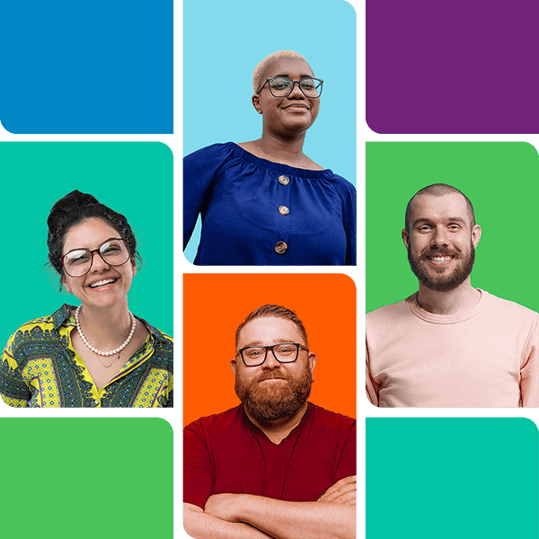 A group of people smiling together, some wearing glasses.
