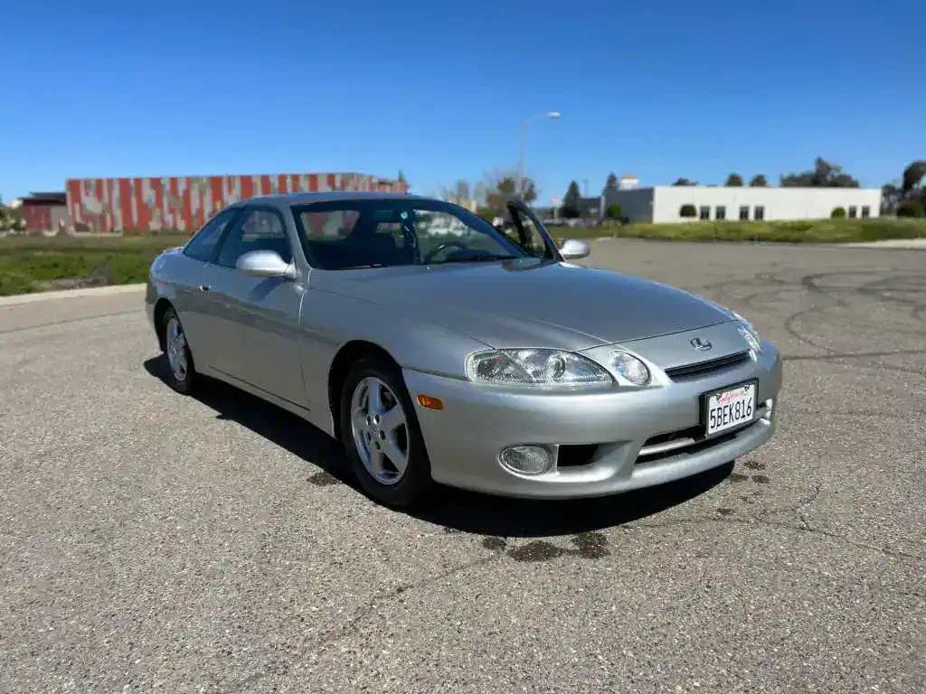 Shiny silver Honda Accord coupe parked outdoors for detailing service.