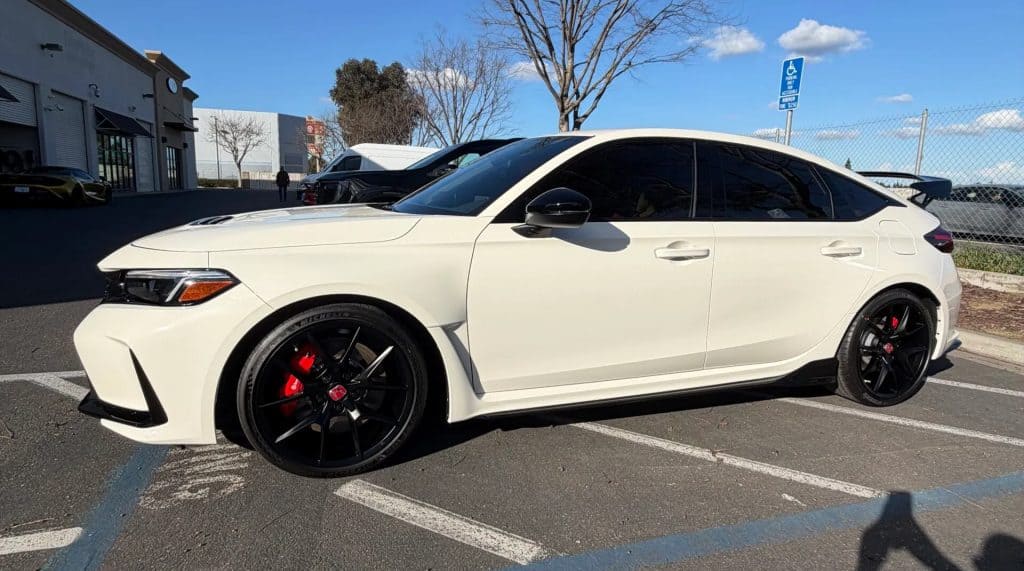 White luxury sedan with black rims and tinted windows at T1Detailing.