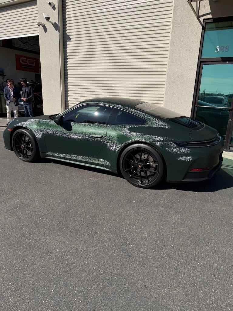 Green sports car with glossy finish parked outside T1Detailing.