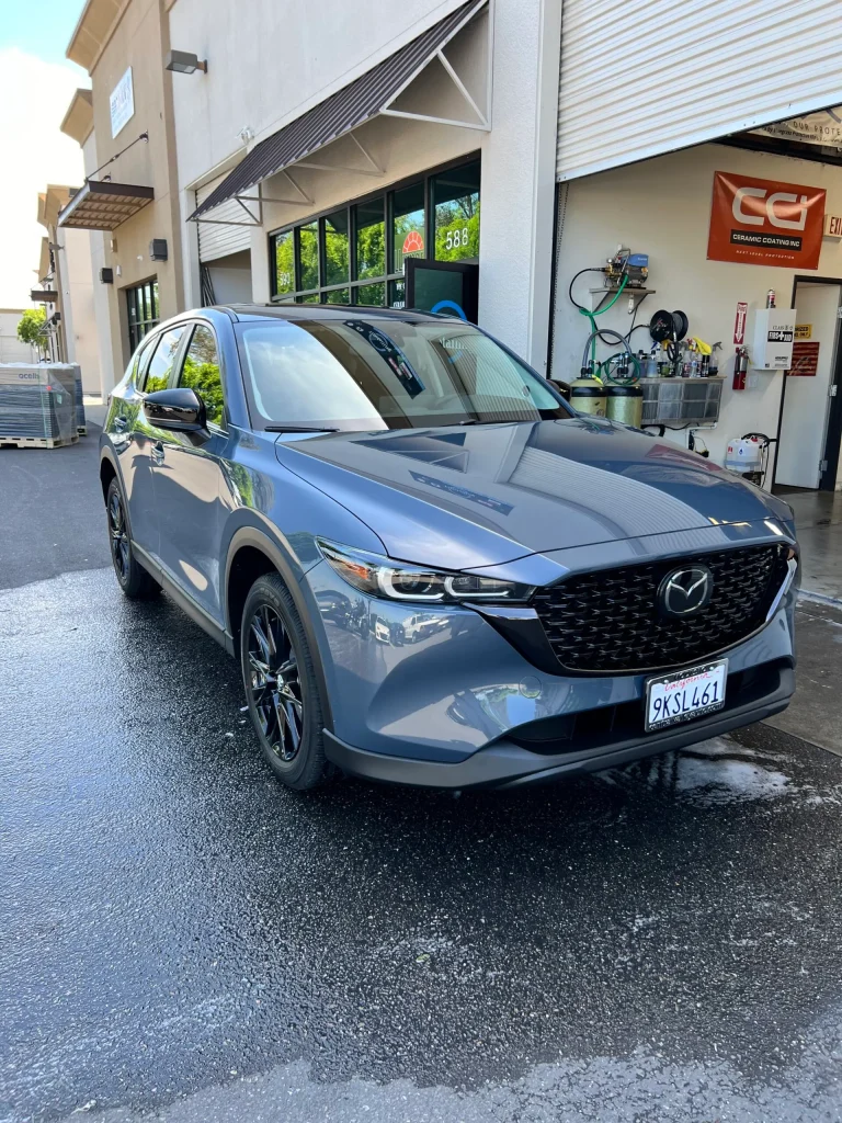 Blue Mazda CX-5 parked at T1Detailing auto service center.