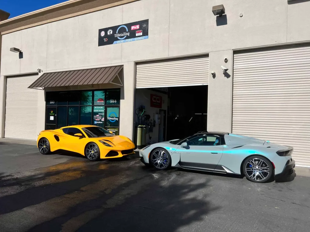 Two luxury sports cars parked outside T1Detailing auto shop.