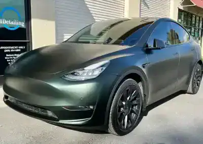Matte green Tesla SUV outside T1Detailing