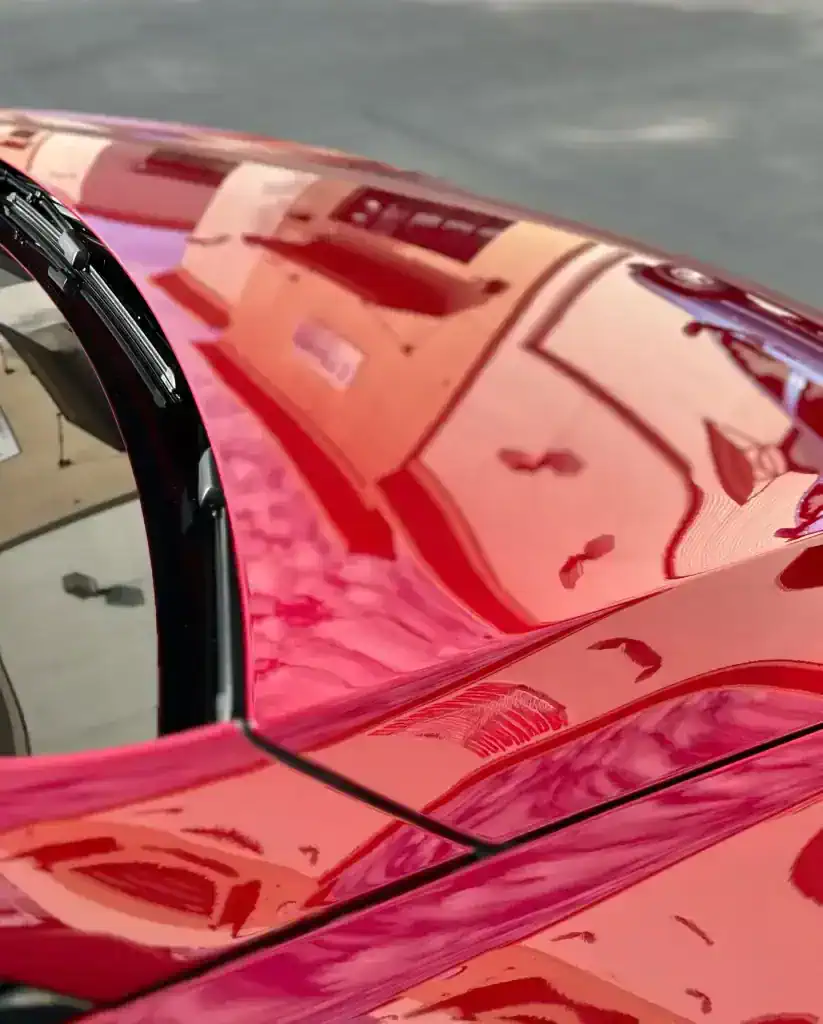 Glossy red vehicle paint after professional detailing