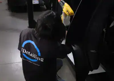 T1Detailing technician working on black vehicle