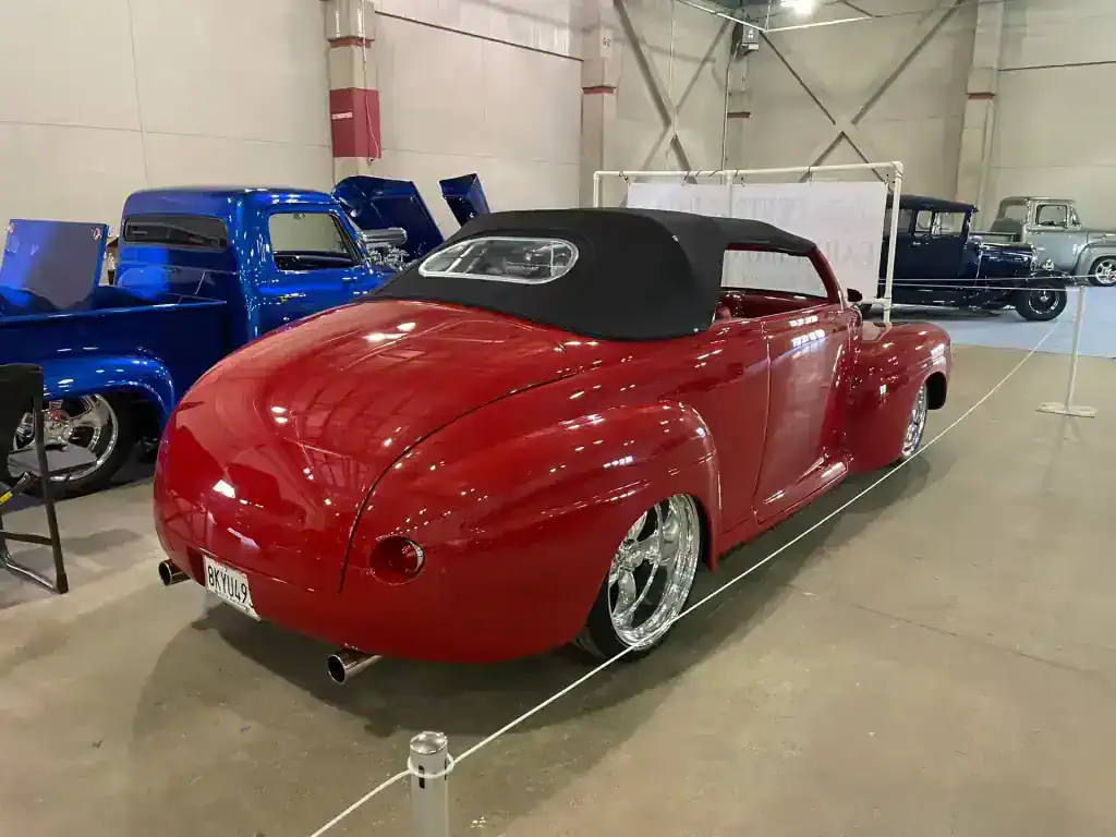Vintage red convertible car with black soft top at T1Detailing.