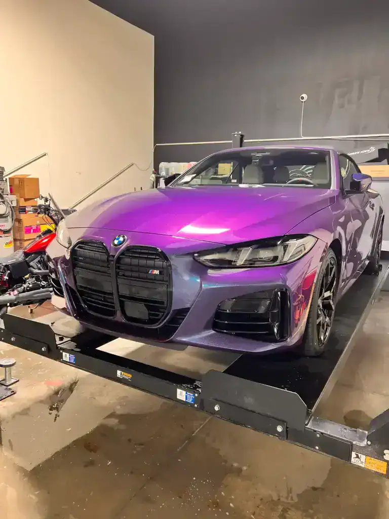 Purple BMW M4 on detailing platform at T1Detailing.