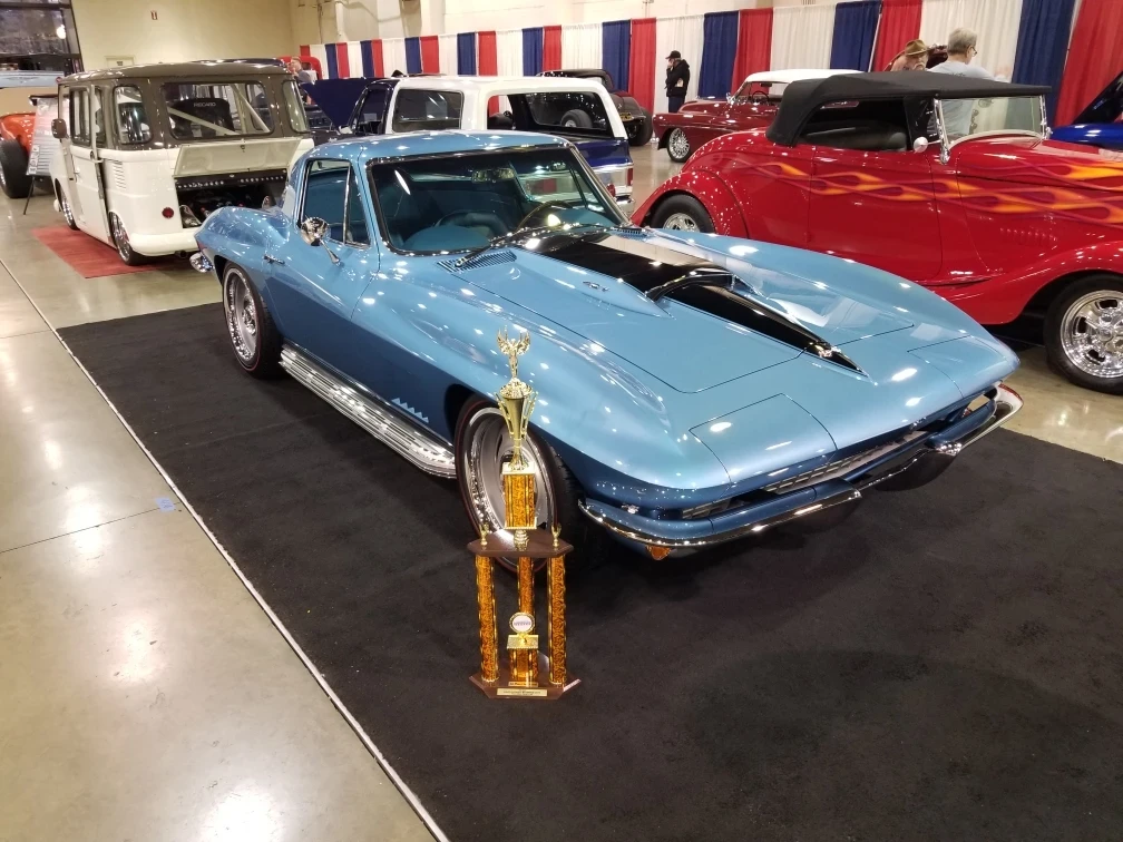 Blue classic Corvette displayed with trophy