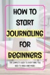 A notebook and pens on a desk with text: Journalling 101—how to start journalling for beginners. The complete guide to everything you need to know (and more).