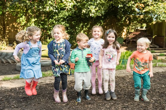 Happy children playing outdoors at Thrive Childcare, fostering early childhood development and social skills in a safe and engaging environment.