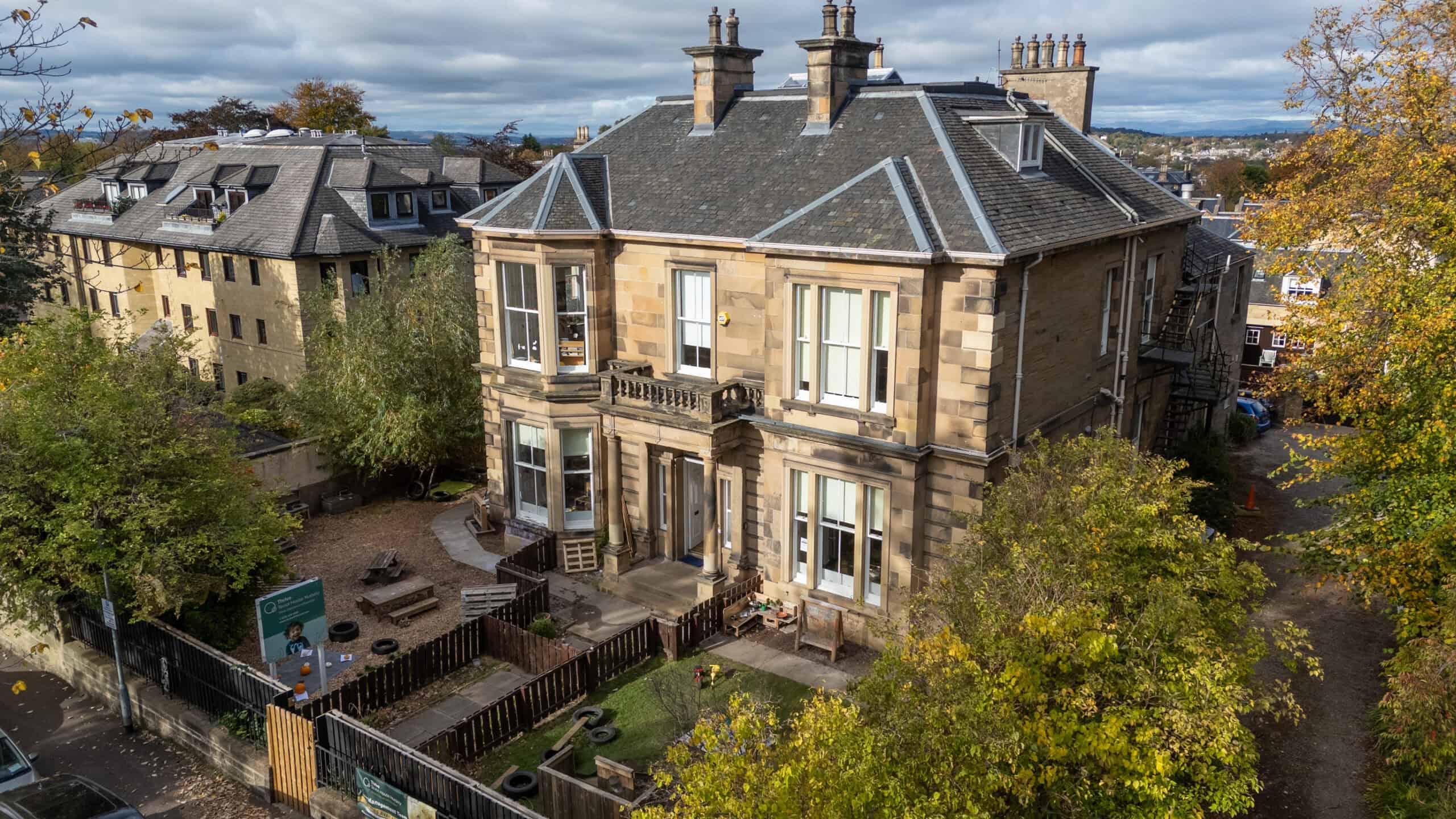 Bright, historic building with large windows, set in a leafy neighbourhood, offering high-quality childcare services in a warm and inviting environment.