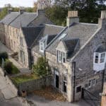 Bright, welcoming childcare centre housed in historic stone building with safe outdoor play area, located in a family-friendly community for early childhood education and care.