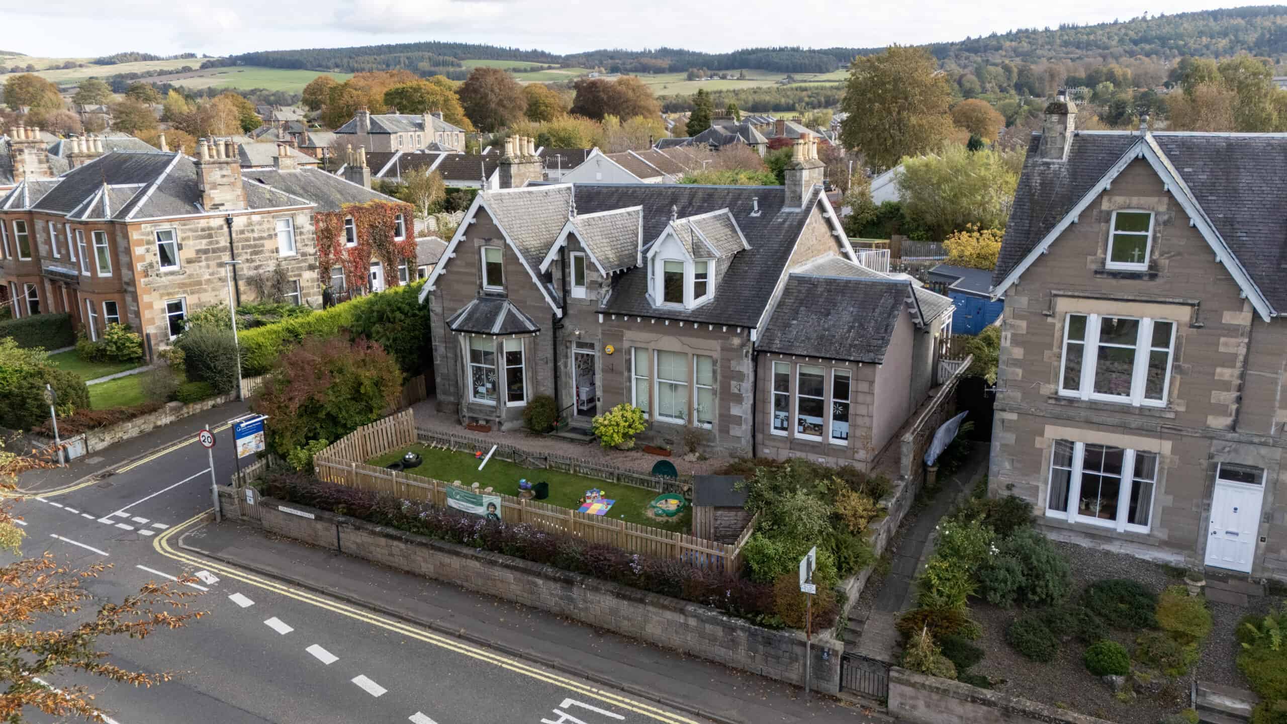 Bright, welcoming childcare centre with garden and outdoor play area, located in a quiet residential neighbourhood with scenic countryside views, ideal for early childhood development and learning.