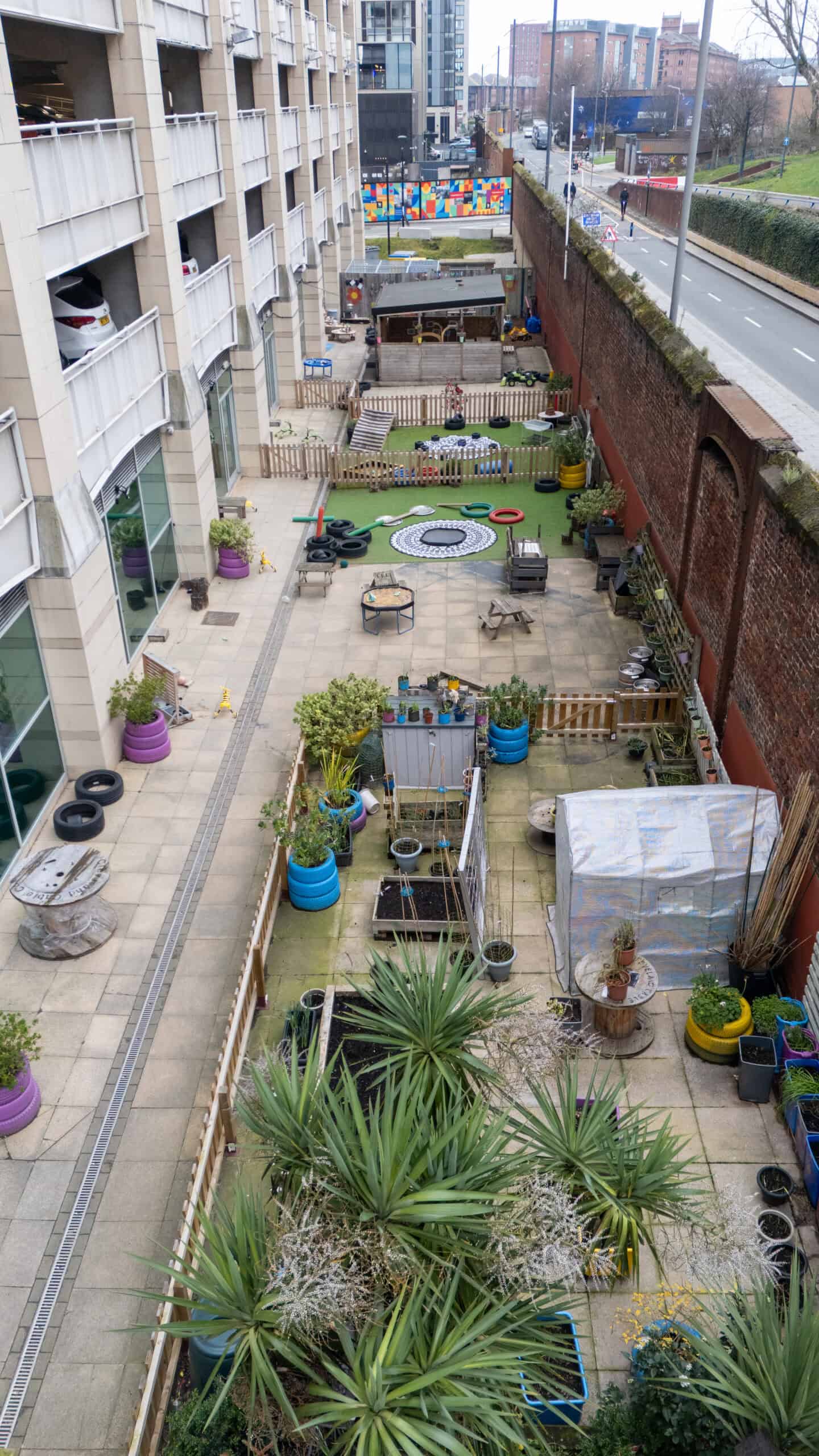 Bright outdoor childcare play area at Holyrood Nursery Princes Dock with colourful toys and safe zones for children.