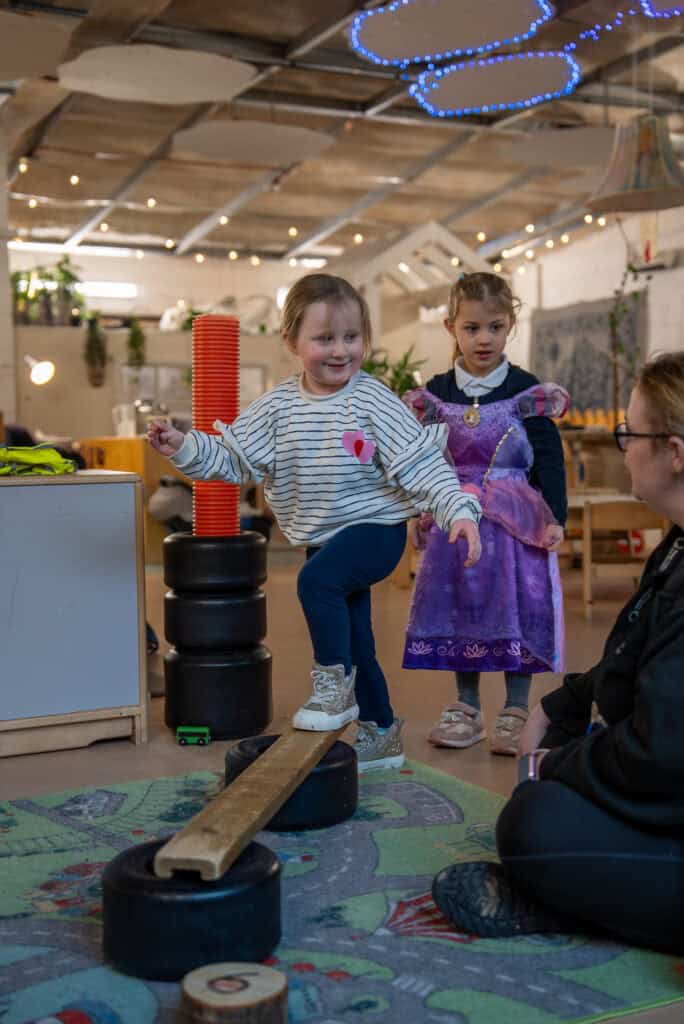 Children engaging in imaginative play and balancing activities at Thrive Childcare's Holyrood Nursery Princes Dock.