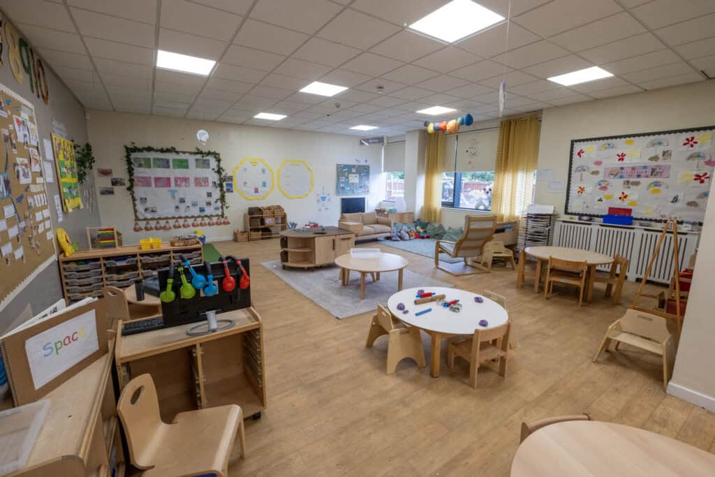 Bright and welcoming childcare indoor learning and play area at Thrive Childcare, featuring age-appropriate furniture, educational activities, and colourful decor to support children's development.