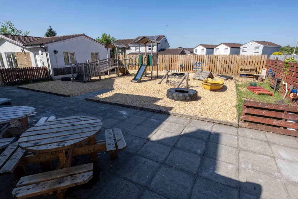 Bright outdoor play area at Thrive Childcare with slides, swings, and sandpit for early childhood development and outdoor fun. Perfect for engaging young children in outdoor activities.