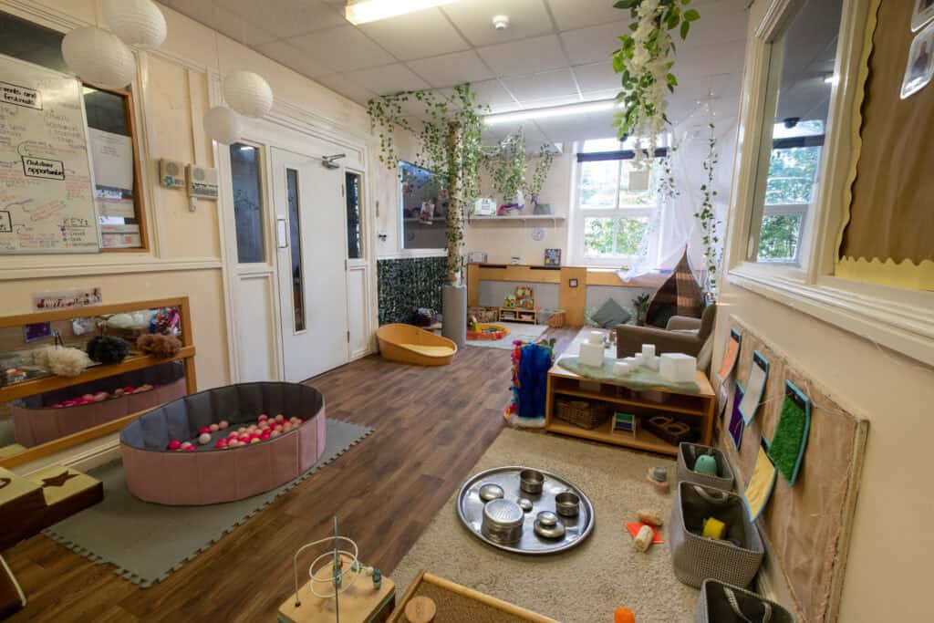 Bright, inviting indoor play area at Thrive Childcare featuring sensory toys, cozy reading nook, and age-appropriate activities to support early childhood development and engaging learning environments.