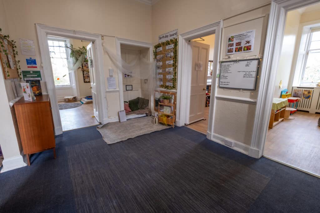 Bright, welcoming hallway of Thrive Childcare with colourful walls, children's artwork, and activity areas, creating a safe and nurturing environment for early childhood learning and development.