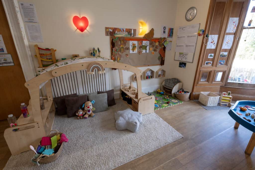 Bright, cosy nursery play area at Thrive Childcare with sensory toys, soft cushions, and creative decor, designed for early childhood development and imaginative play.