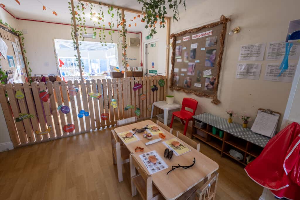 Bright childcare classroom at Thrive Childcare with educational displays, child-sized furniture, and playful learning materials, creating a safe and nurturing environment for early childhood development.