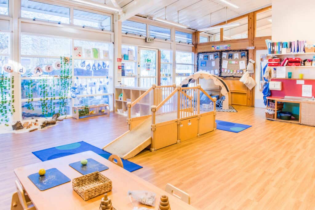1. Bright and spacious childcare room at Thrive Childcare with natural light, safe play area, and educational materials for young children.