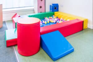 Bright colourful indoor play area at Thrive Childcare with a ball pit for safe, fun children's activities and development.