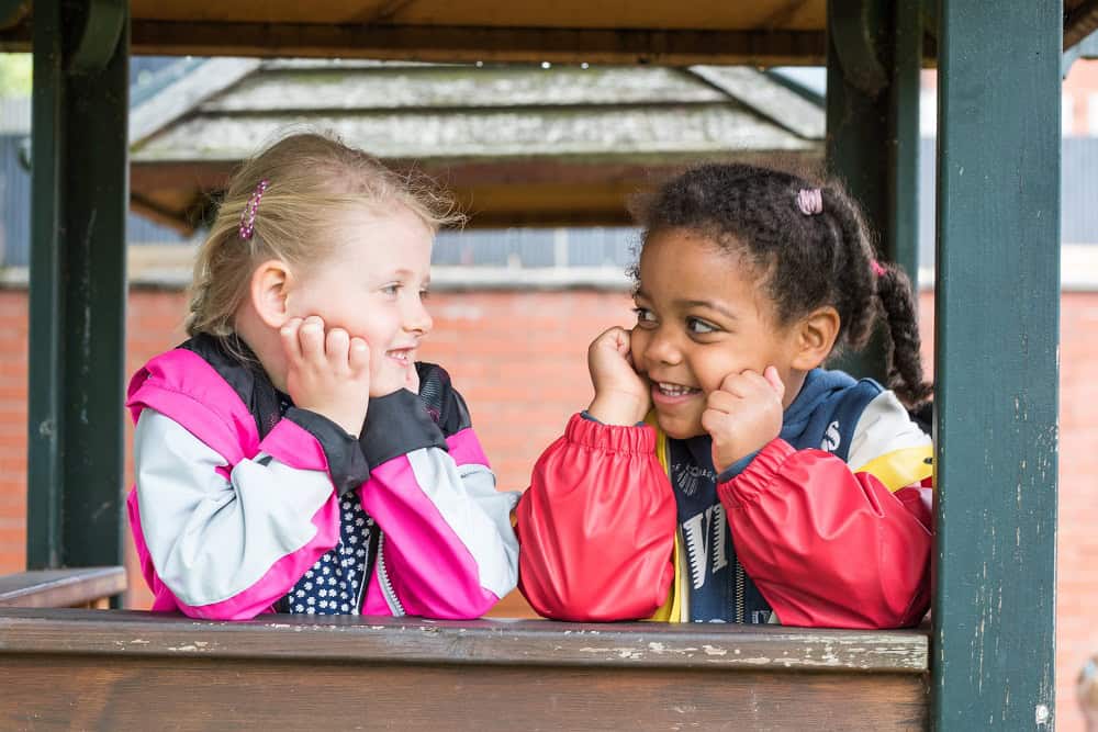 Playful young children enjoying outdoor play at Thrive Childcare, promoting safe, engaging, and nurturing early childhood education environments.