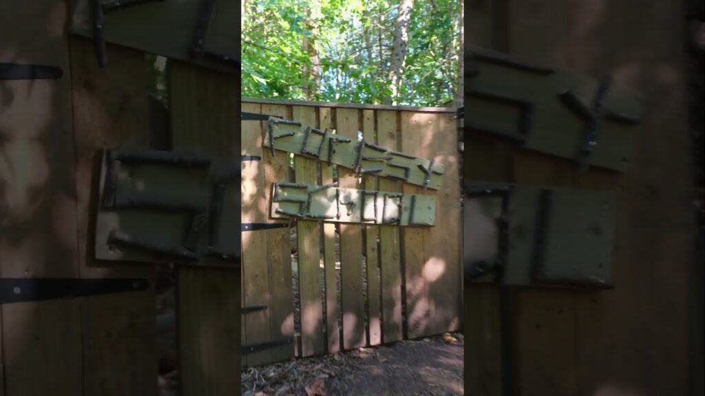 Children's outdoor play area at Thrive Childcare with wooden chairs and tables, surrounded by nature, promoting outdoor learning and socialisation. Ideal for enriching early childhood development.