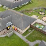 Bright outdoor play area at Thrive Childcare with sandpits, climbing equipment, and seating for children’s activities and outdoor learning.