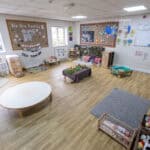 Colourful indoor childcare classroom at Thrive Childcare, filled with toys, play areas, and educational displays, designed to promote early childhood development and family engagement.