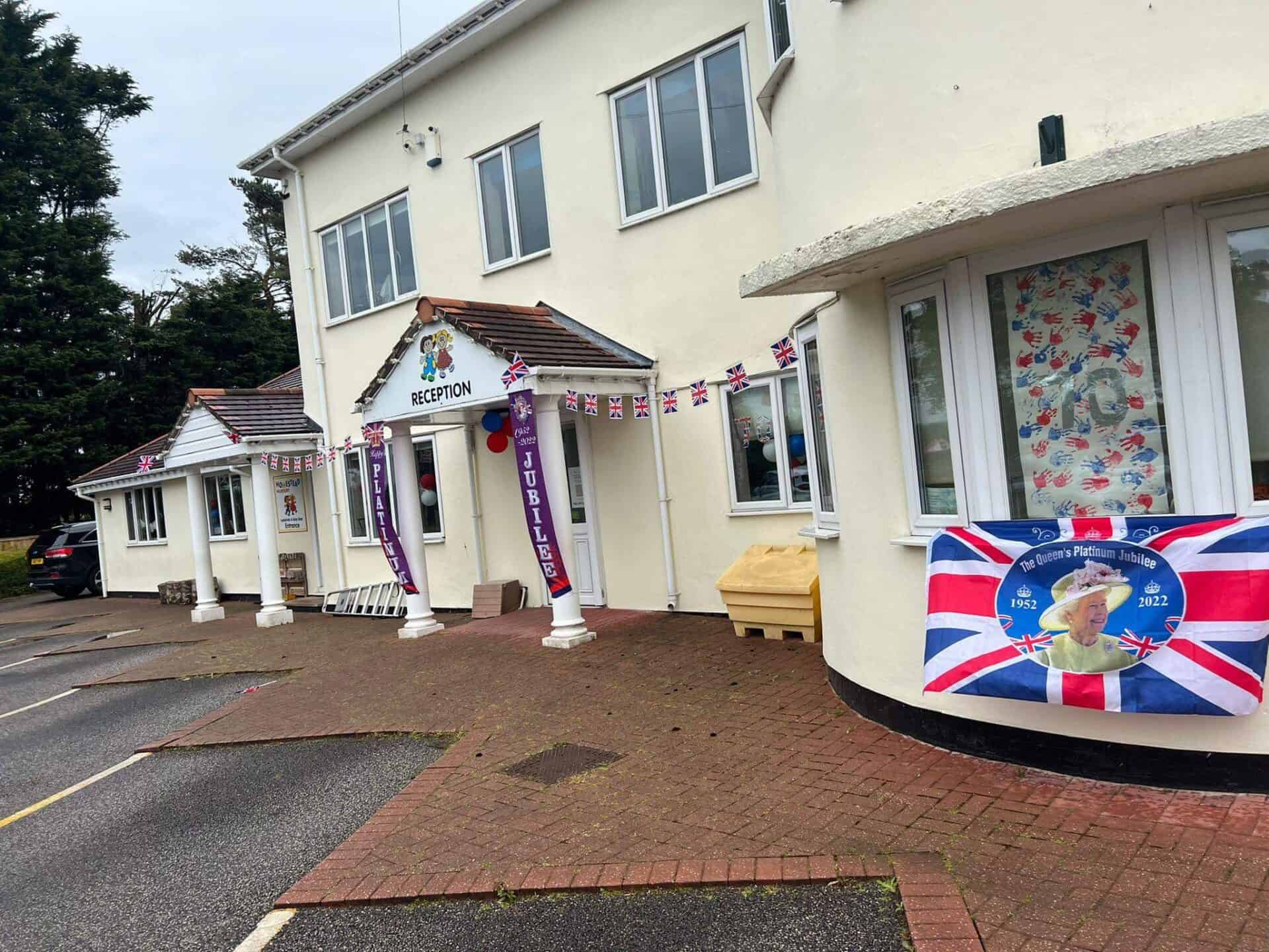 Bright and inviting childcare centre decorated for the Queen's Platinum Jubilee celebration with Union Jack banners, themed posters, and a welcoming reception area, emphasising a safe and joyful environment for children.