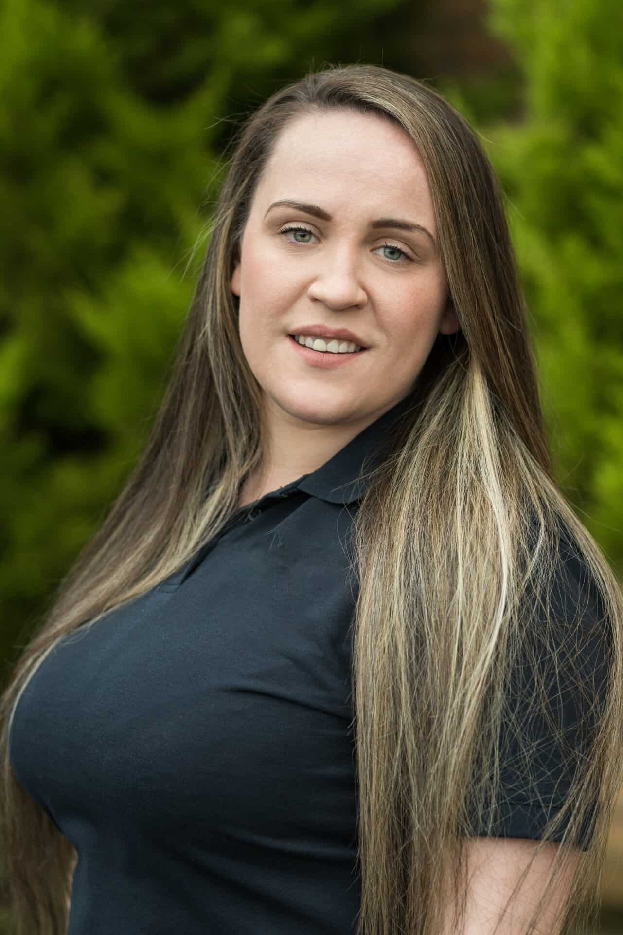 Dedicated female childcare professional outdoors at Thrive Childcare, demonstrating care and professionalism in early childhood education and support.