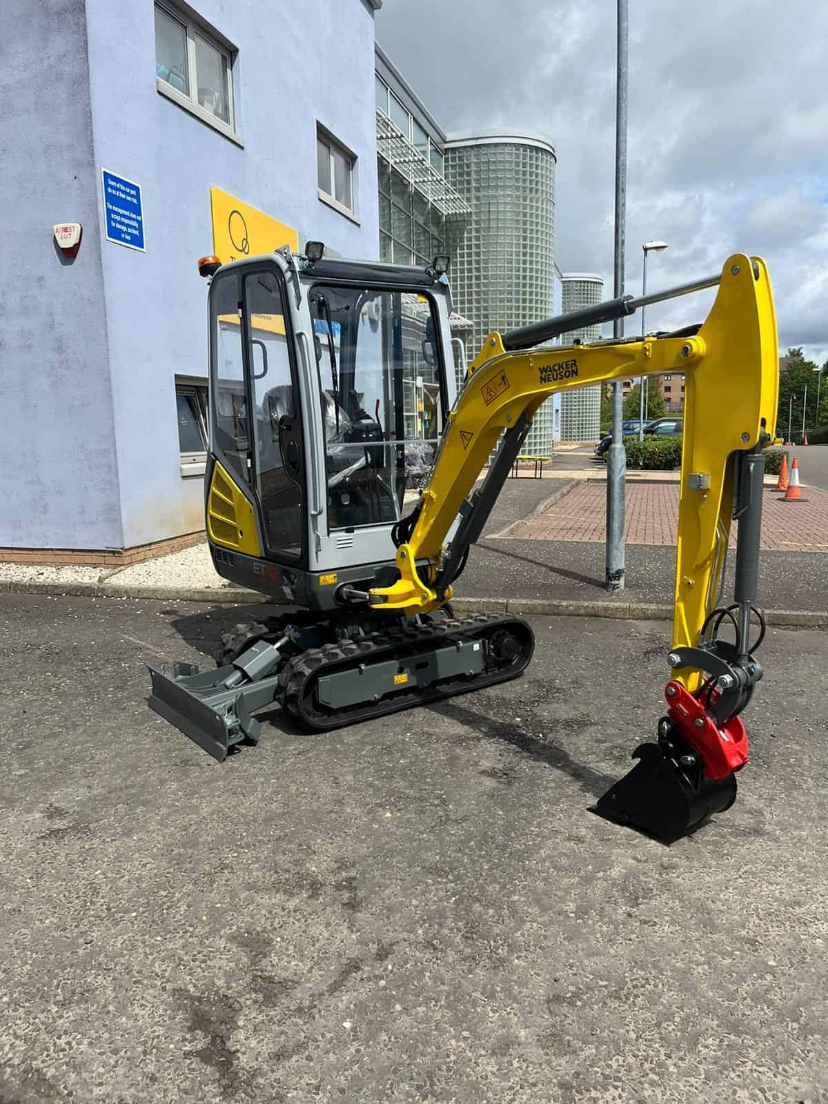 Mini excavator parked outside Thrive Childcare, showcasing modern construction equipment, reflecting care and development in early childhood education and facility improvements.