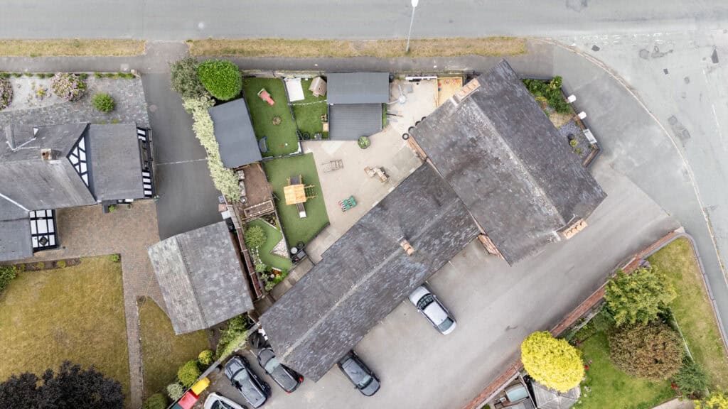 Bright aerial view of Thrive Childcare outdoor play area with engaging toys, green spaces, and secure fencing, offering a safe, nurturing environment for children’s play and development.