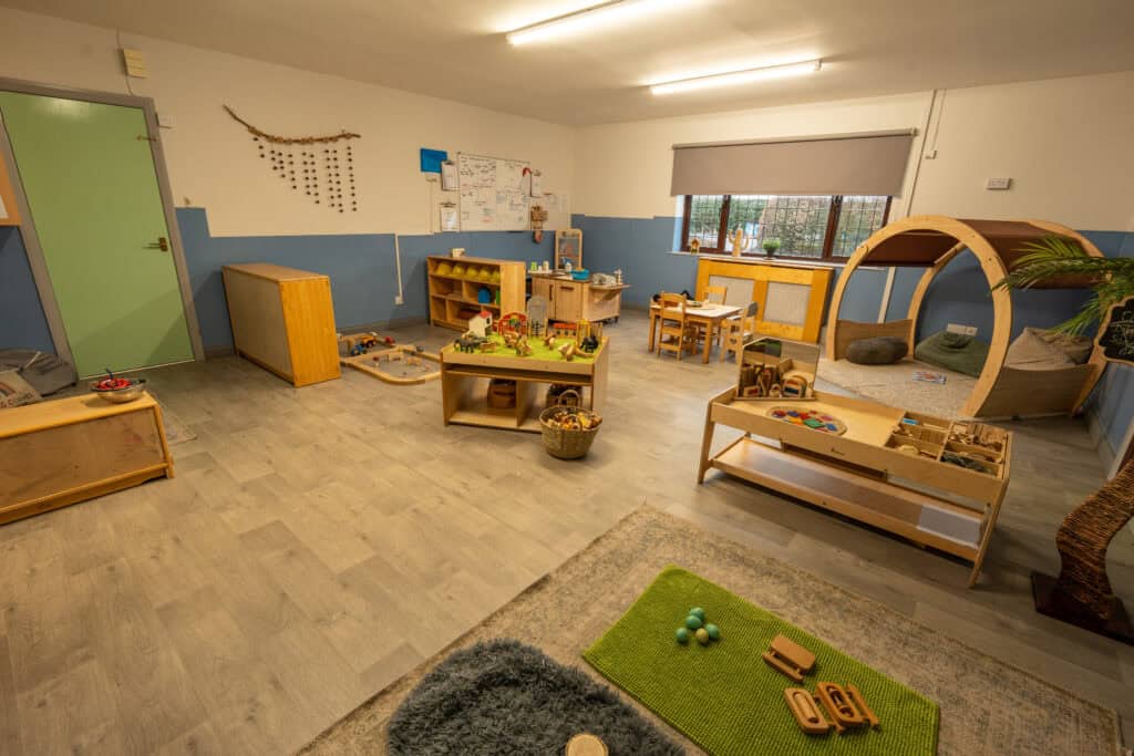 An inviting indoor playroom at Thrive Grosvenor House, designed for early childhood development with toys, activities, and cozy spaces for children to learn and play safely.